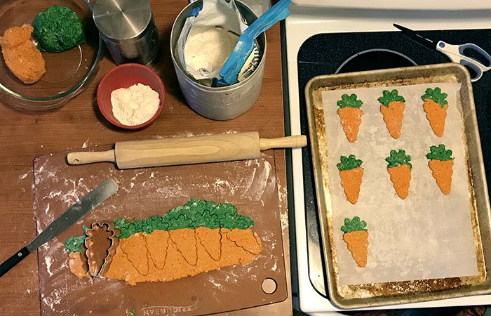 rolling out easter bunny carrot dog cookies 