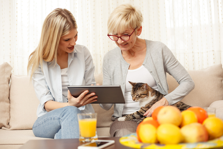 Two women discuss a cat.