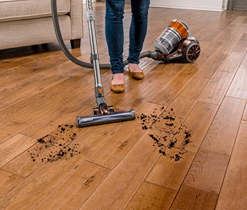 Bissell corded bagless canister vacuum in action on hardwood floor