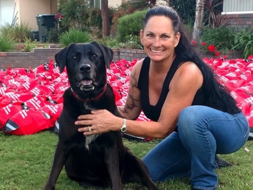 Debra Jo Chiapuzio with dog Emma Zen in front of pet oxygen masks
