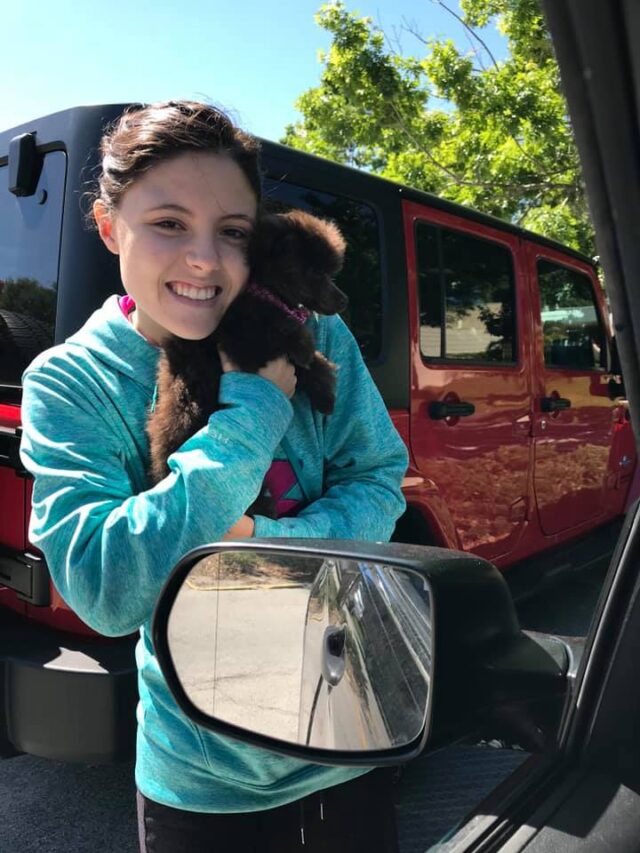 Girl hugging tiny puppy