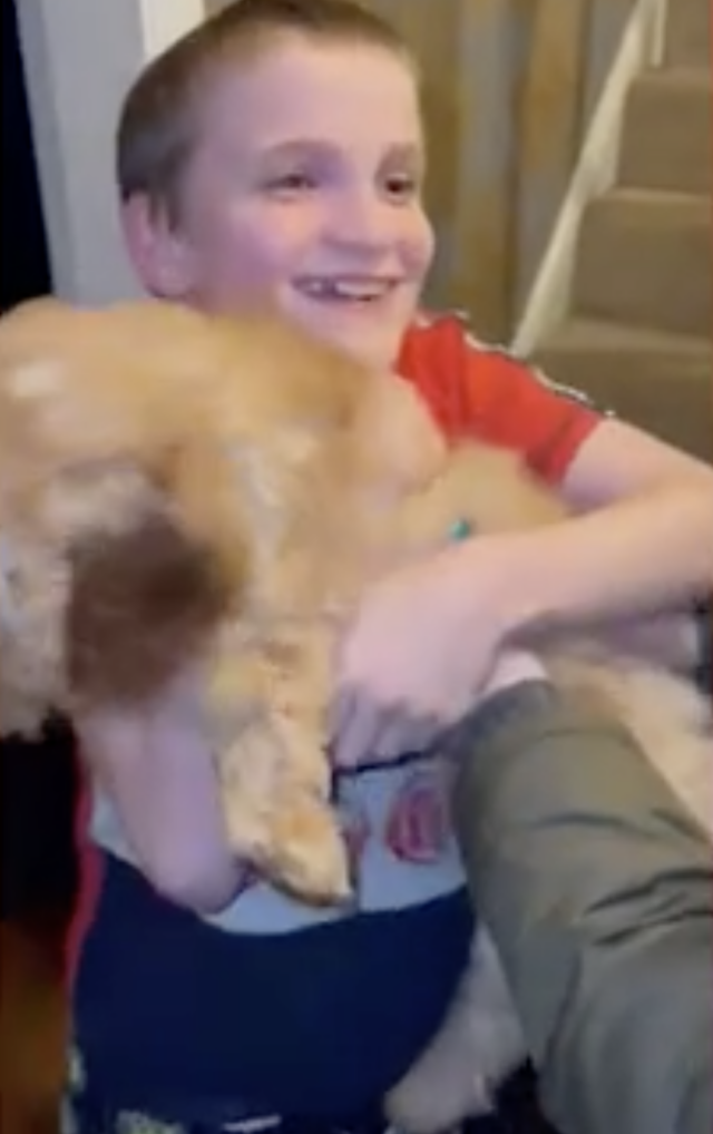 Boy holding his puppy