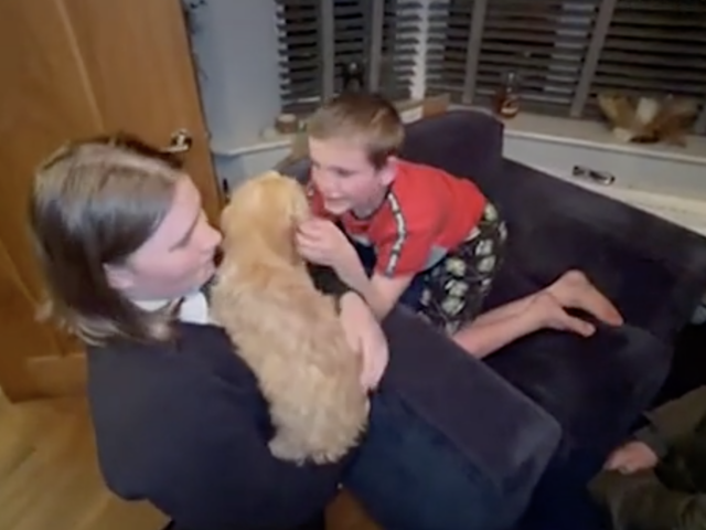 Family cuddling new puppy